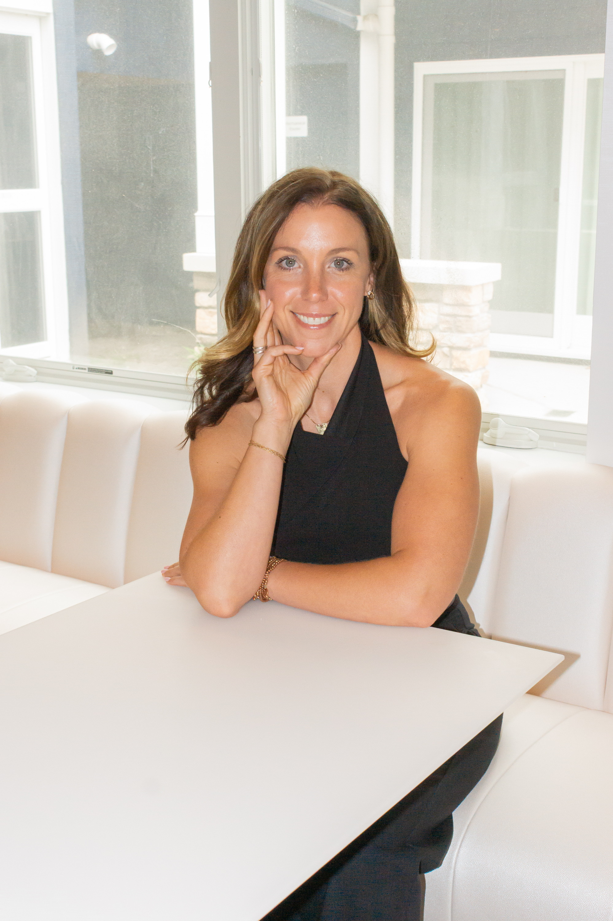 Ali Lacroix smiling at a white table